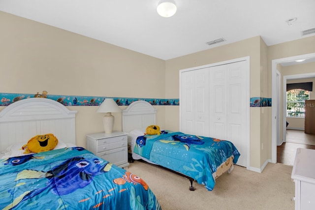 bedroom featuring a closet and light colored carpet