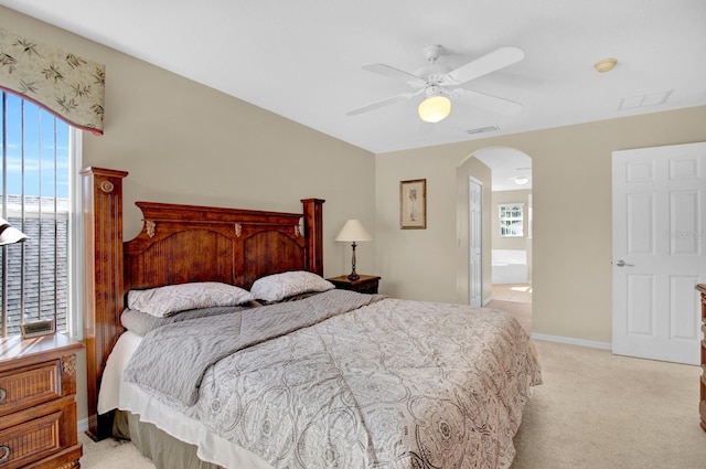 carpeted bedroom featuring ensuite bathroom and ceiling fan