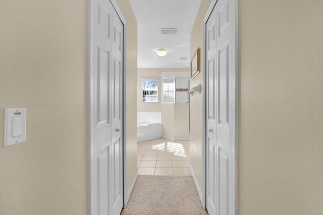 hall with light tile patterned flooring