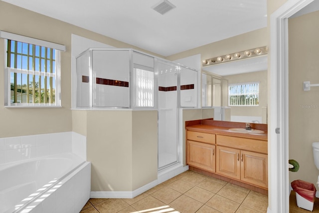 full bathroom with toilet, vanity, tile patterned floors, and independent shower and bath