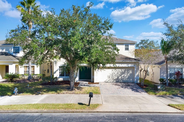 view of property hidden behind natural elements with a garage