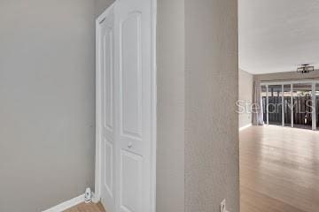 corridor with hardwood / wood-style flooring