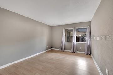 spare room with light hardwood / wood-style floors