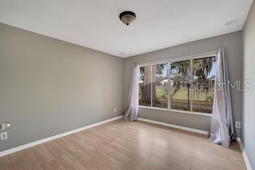 unfurnished room with light wood-type flooring