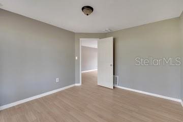 spare room featuring light hardwood / wood-style flooring