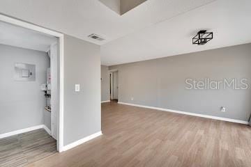 unfurnished room with hardwood / wood-style flooring