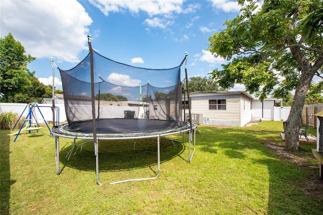 view of yard featuring a playground and a trampoline