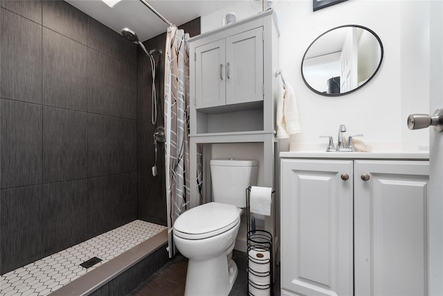 bathroom with vanity, toilet, and walk in shower