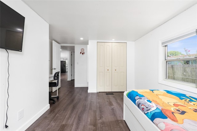 unfurnished bedroom with a closet and dark hardwood / wood-style floors