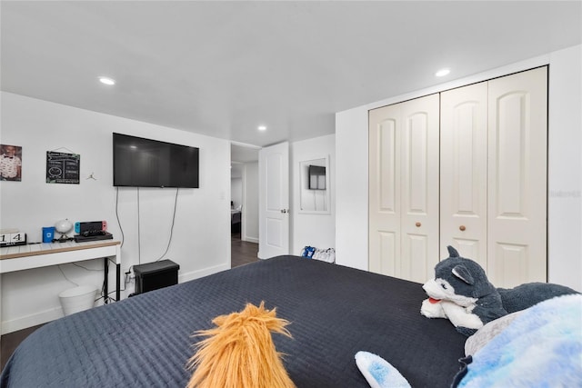 bedroom with a closet and dark hardwood / wood-style floors