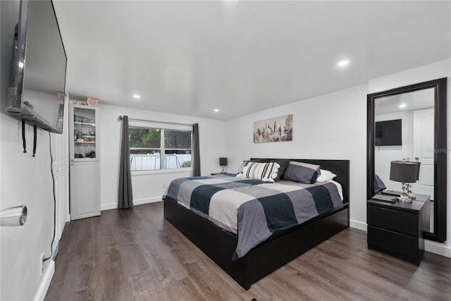 bedroom with dark wood-type flooring