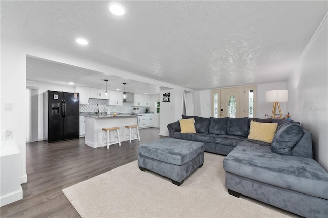 living room with hardwood / wood-style floors and a textured ceiling