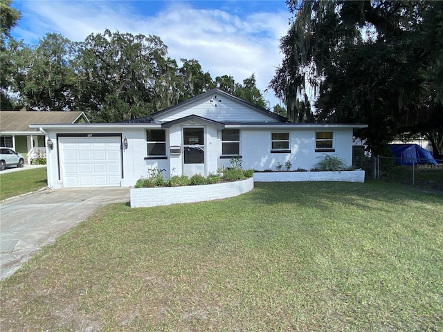 ranch-style home with a garage and a front lawn