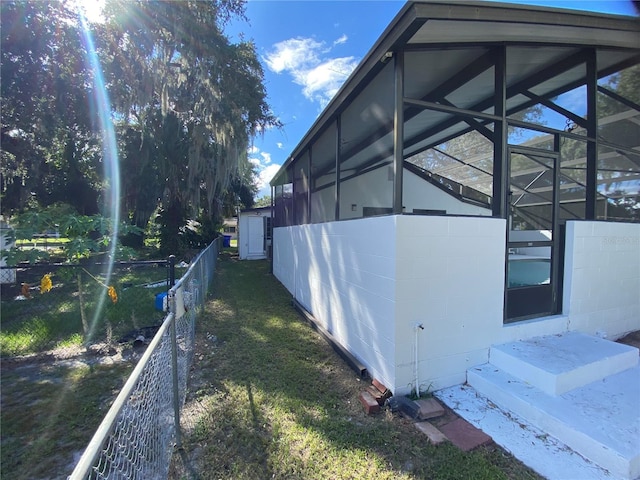 view of property exterior featuring glass enclosure