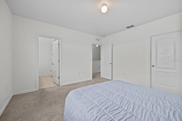 carpeted bedroom with connected bathroom