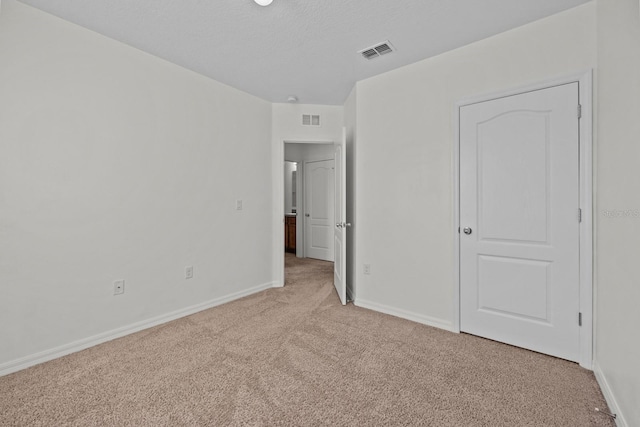 unfurnished bedroom with light carpet