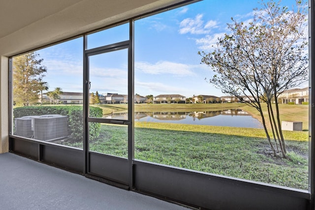 unfurnished sunroom with plenty of natural light and a water view