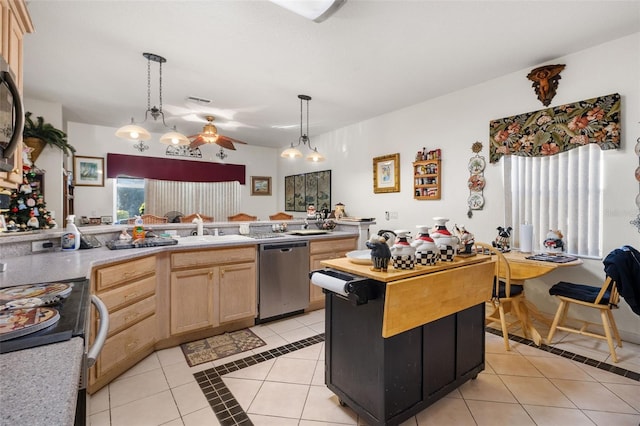 kitchen featuring decorative light fixtures, light tile patterned flooring, stainless steel appliances, and light brown cabinetry