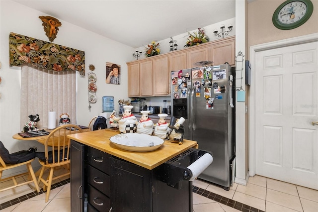 kitchen featuring light brown cabinets, light tile patterned flooring, and stainless steel refrigerator with ice dispenser