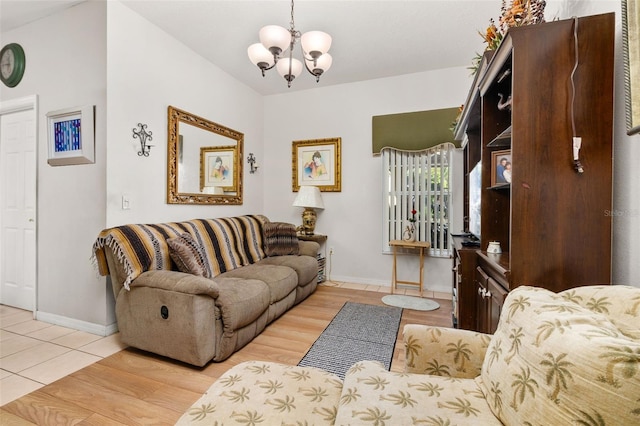 living room featuring a chandelier and light wood-type flooring