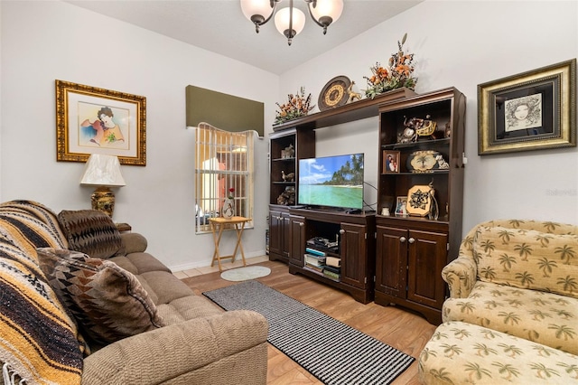 living room featuring light hardwood / wood-style floors and a chandelier