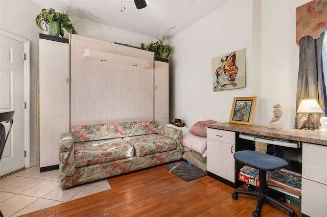 office with ceiling fan, light wood-type flooring, lofted ceiling, and a wall unit AC