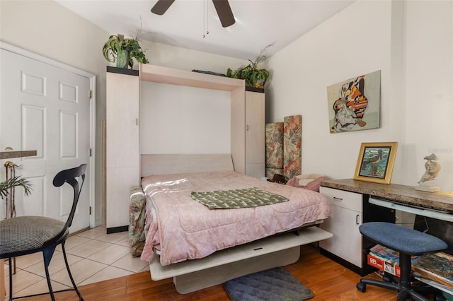 tiled bedroom featuring ceiling fan