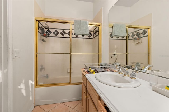 bathroom with tile patterned floors, vanity, and enclosed tub / shower combo