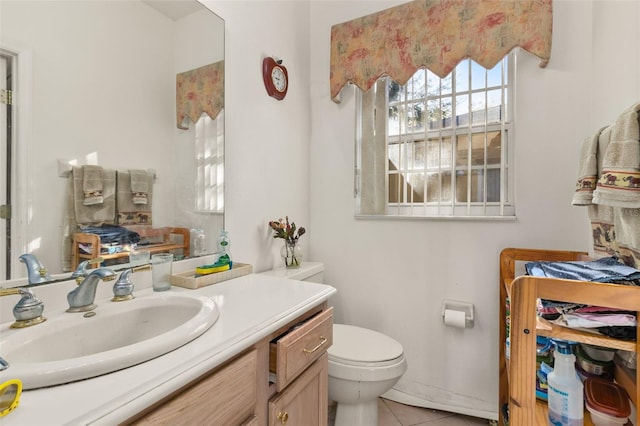 bathroom featuring tile patterned flooring, vanity, and toilet