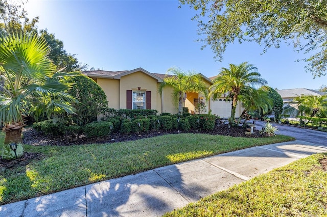 view of front facade with a garage and a front lawn