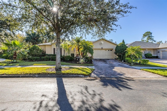 view of front of property with a front lawn and a garage