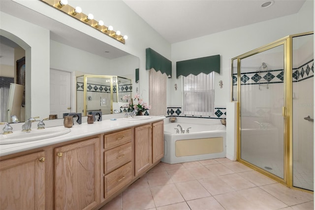 bathroom with tile patterned flooring, vanity, and separate shower and tub