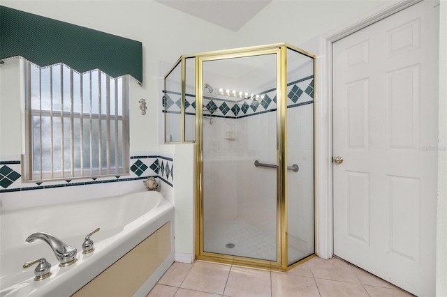 bathroom featuring tile patterned floors and separate shower and tub