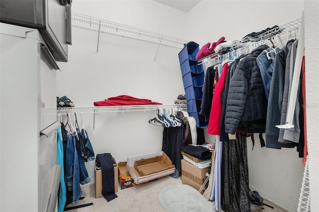 walk in closet with carpet flooring