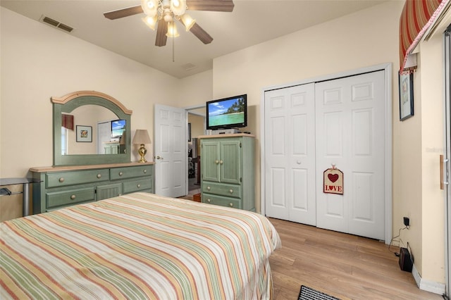 bedroom featuring light wood-type flooring, a closet, and ceiling fan