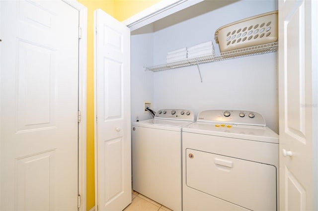 washroom featuring light tile patterned flooring and separate washer and dryer