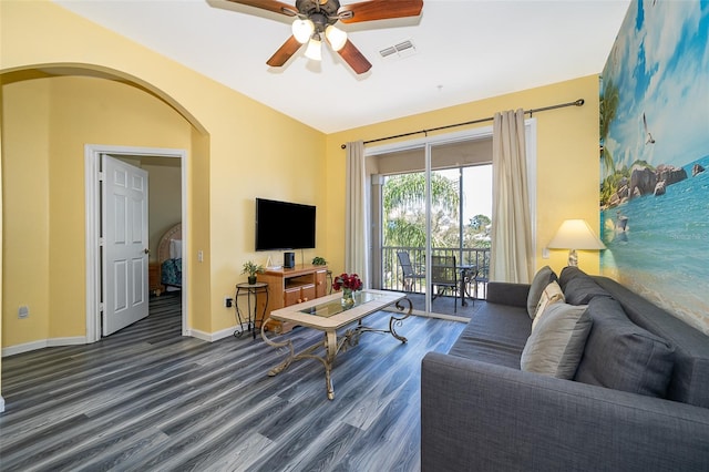 living room with ceiling fan, dark wood-type flooring, and vaulted ceiling