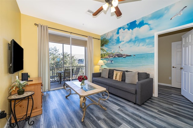 living room with ceiling fan, dark hardwood / wood-style flooring, a beach view, and a water view