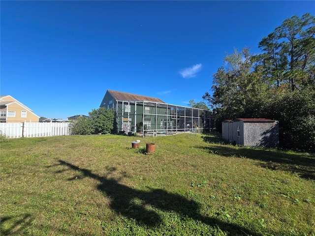 view of yard with a lanai and a storage unit