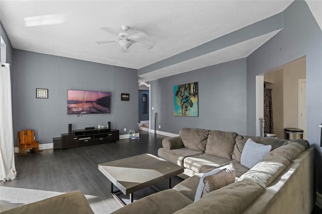 living room featuring ceiling fan and dark hardwood / wood-style flooring