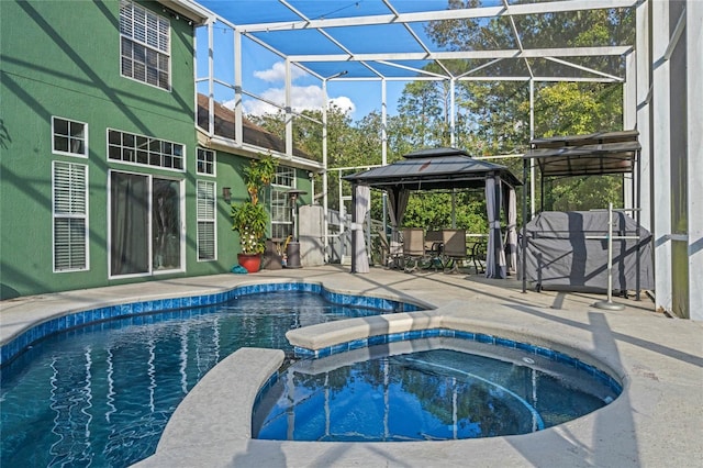 view of pool featuring a gazebo, a patio area, an in ground hot tub, and glass enclosure