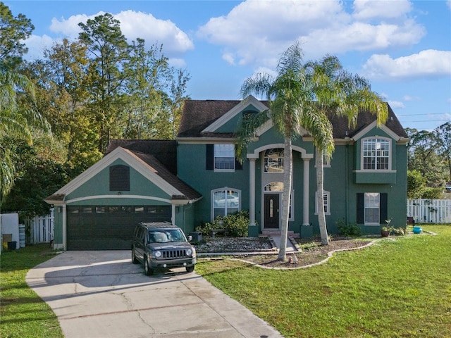 view of front of property featuring a front lawn and a garage