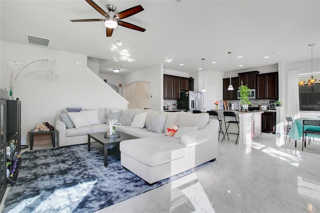 2811 Sonata Ct, Saint Cloud, FL 34772 - living area featuring a ceiling fan, light marble finish floors, recessed lighting, and a chandelier