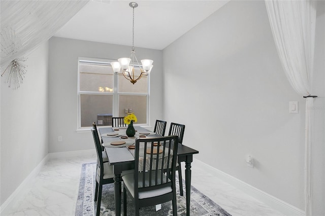 2811 Sonata Ct, Saint Cloud, FL 34772 - dining room featuring light marble finish floors, a chandelier, and baseboards