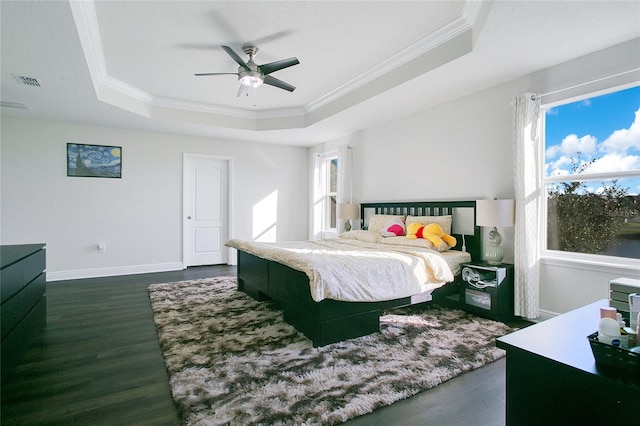 bedroom with multiple windows, dark wood-type flooring, and ceiling fan