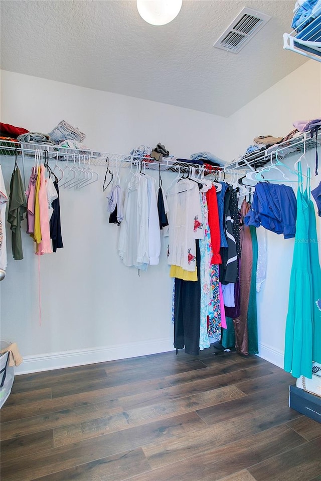 walk in closet featuring dark hardwood / wood-style flooring