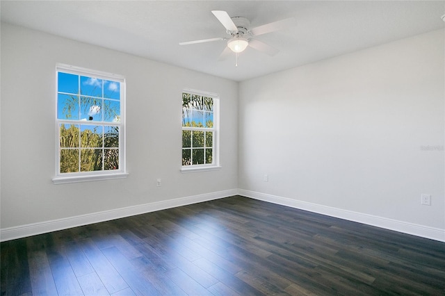 spare room with ceiling fan and dark wood-type flooring