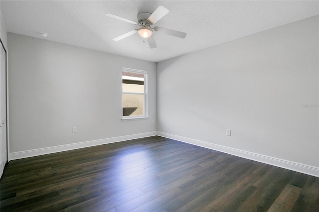 unfurnished room with ceiling fan, dark hardwood / wood-style flooring, and a textured ceiling