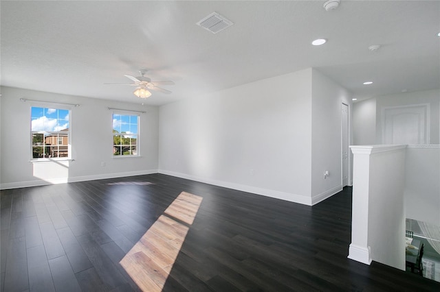 spare room with dark hardwood / wood-style floors and ceiling fan