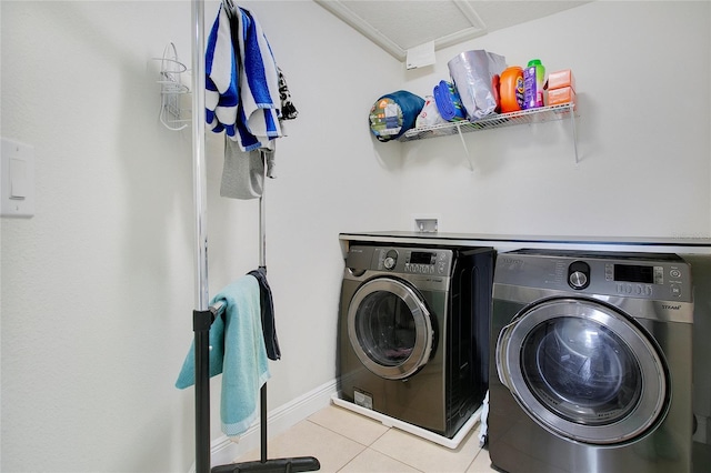 laundry area with light tile patterned flooring and washer and dryer